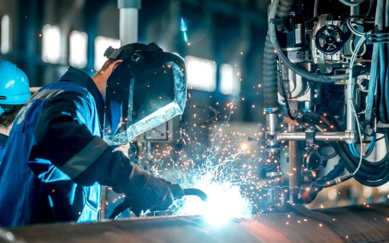 man welds at the factory