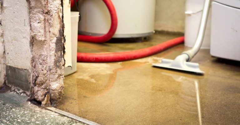 a flooded basement with water and vaccuum