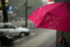 a red umbrella with rain drops