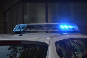 a police vehicle with lights activated on the roof