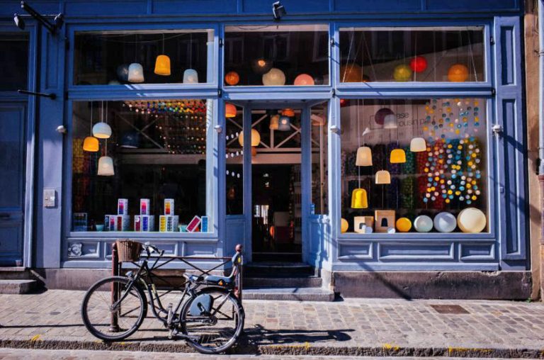 a storefront building with a bicycle parked outside